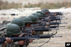 FILE - In this Oct. 31, 2018, photo, Afghan National Army soldiers participate in a live fire training exercise, at the Afghan Military Academy, in Kabul.