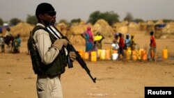 FILE - A Nigerien soldier stands guard in a camp of the city of Diffa during the visit of Niger's Interior Minister Mohamed Bazoum following attacks by Boko Haram fighters in the region of Diffa, Niger, June 18, 2016.