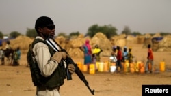 FILE - A Nigerien soldier stands guard in a camp in the city of Diffa following attacks by Boko Haram fighters in the region, June 18, 2016.