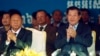 Cambodian Prime Minister Hun Sen, front right, applauds together with the National Assembly President Heng Samrin, front left, during an event by the ruling Cambodian People's Party marking the 36th anniversary of the 1979 downfall of the Khmer Rouge regi