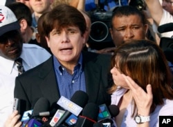 FILE - In this March 14, 2012 file photo, former Illinois Gov. Rod Blagojevich, accompanied by his wife Patti, speaks to the media outside his home in Chicago.