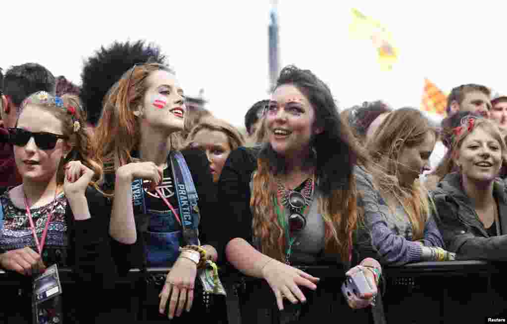 Festival-goers wait for singer Rita Ora to perform on the third day of the Glastonbury music festival at Worthy Farm in Somerset, Britain. 