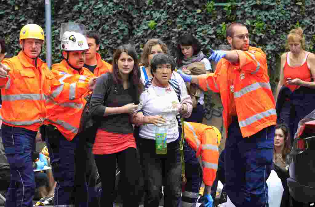 Paramedics help injured people after an explosion in downtown Prague, Czech Republic. 