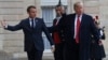 President Donald Trump is greeted by French President Emmanuel Macron after arriving at the Elysee Palace in Paris, Nov. 10, 2018. 