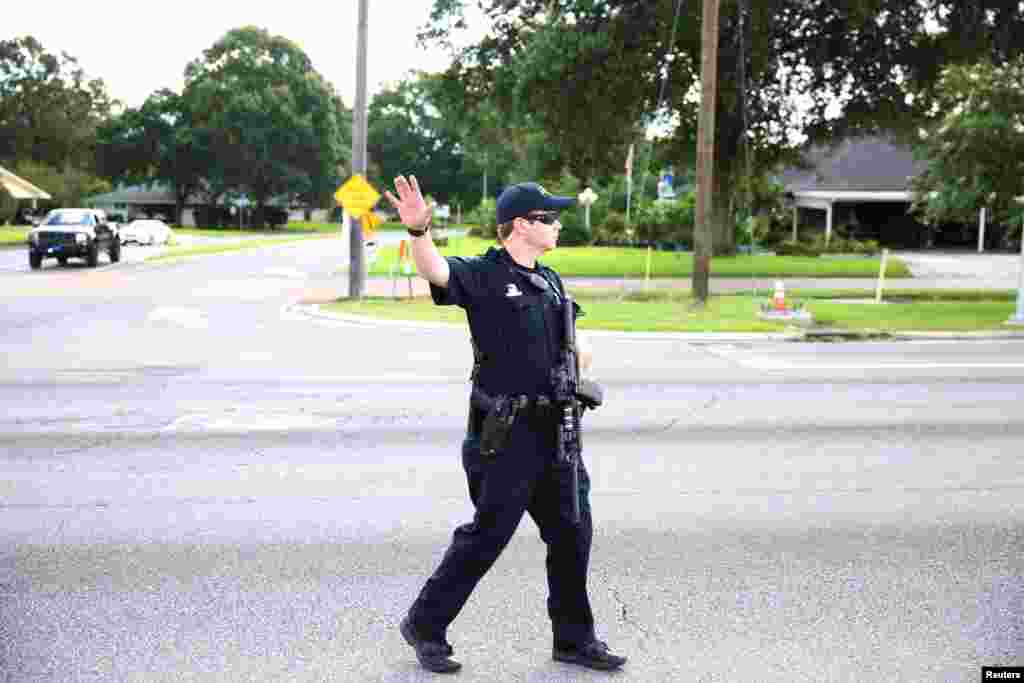 Police officers block off a road near the site of a shooting of police in Baton Rouge, July 17, 2016.