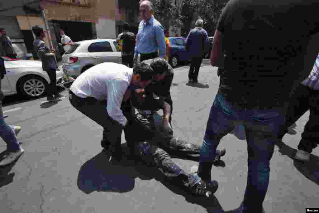 People help an injured man after an earthquake hit Mexico City, Sept. 19, 2017.