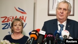 Czech President Milos Zeman, with his wife Ivana in the background, attends a news conference, after polling stations closed for the country's presidential election, in Prague, Czech Republic, Jan. 13, 2018.
