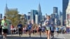 FILE - Runners make their way down 44th Drive in the Queens borough of New York during the New York City Marathon on Sunday, Nov. 6, 2011.