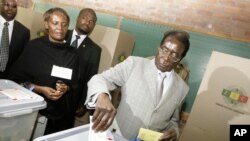 FILE - Zimbabwe's President Robert Mugabe, casts his vote on election day in Harare, Zimbabwe, Saturday, March 29, 2008.