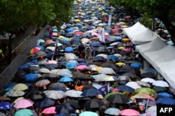 Gay rights supporters wait for the results under the rain outside Parliament while lawmakers discuss the same-sex marriage bill in Taipei, May 17, 2019.