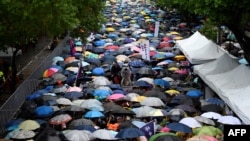 Gay rights supporters wait for the results under the rain outside Parliament while lawmakers discuss the same-sex marriage bill in Taipei, May 17, 2019.