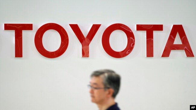 A visitor walks through a Toyota showroom in Tokyo, Aug. 3, 2018.