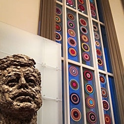 Bharti Kher's bindi art sculptures hang in the Kennedy Center's Grand Foyer next to a statue of President John F. Kennedy
