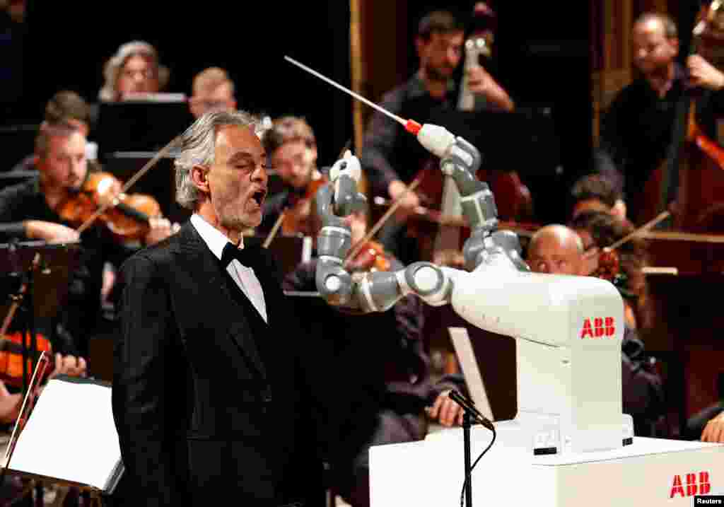 Humanoid robot YuMi conducts the Lucca Philharmonic Orchestra performing a concert alongside Italian tenor Andrea Bocelli at the Verdi Theatre in Pisa, Italy, Sept. 12, 2017.