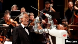 Humanoid robot YuMi conducts the Lucca Philharmonic Orchestra performing a concert alongside Italian tenor Andrea Bocelli at the Verdi Theatre in Pisa, Italy September 12, 2017.