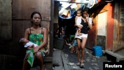Residents are seen outside their shanties in Navotas, Metro Manila, Philippines, Oct. 28, 2017. An U.N. report looked at the economic future of Asia, including poverty, which remains “relatively high” in South and Southwest Asia. 
