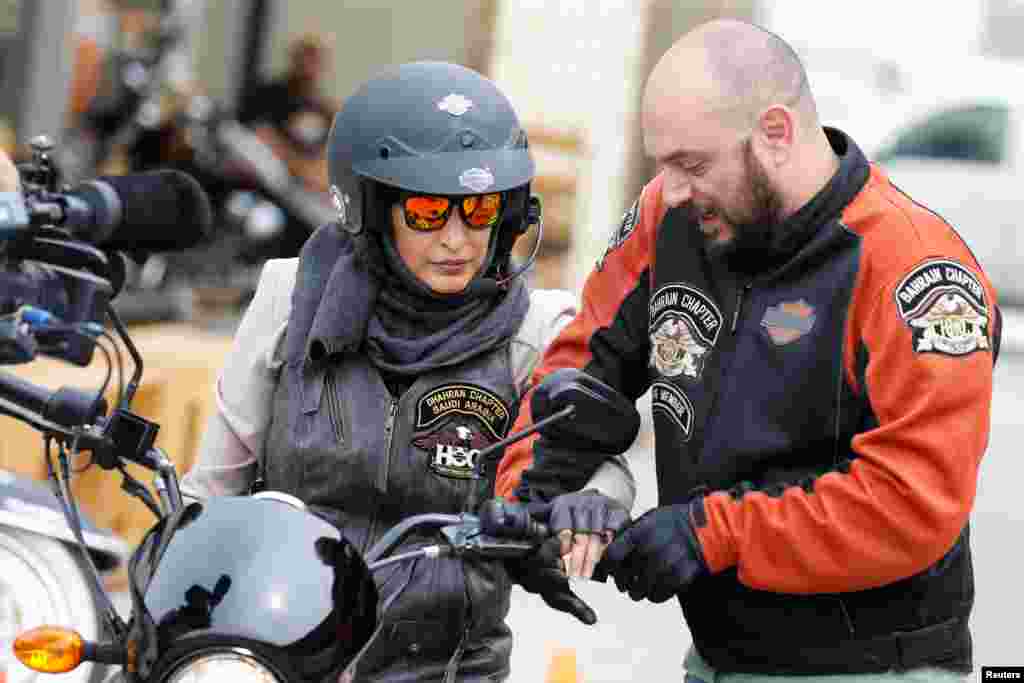 Maryam Ahmed Al-Moalem, a Saudi female bike rider, is given basics of operating a bike by Rebal Mohammed trainer, during her lessons in advanced motorbike training at Harley Davidson training centre in Manama, Bahrain.