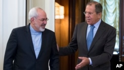 FILE - Iranian Foreign Minister Mohammad Javad Zarif, left, and Russian Foreign Minister Sergey Lavrov enter a hall for their talks in Moscow, Russia, Aug. 29, 2014.