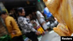 FILE - A chicken is displayed for sale at a market in Phnom Penh.