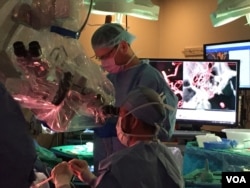 Neurosurgeon Dr Gary Steinberg conducts the operation through a surgical microscope and his naked eye, while the virtual reality images are available for reference. Steinberg clipped an aneurysm during the five-hour surgery.