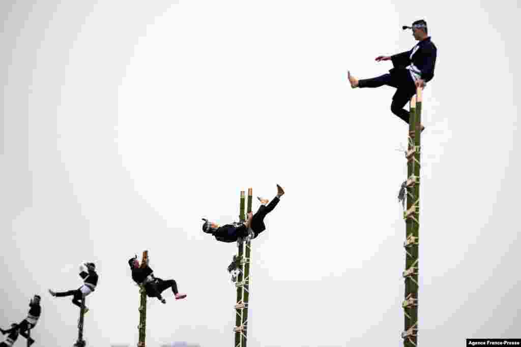 Members of the Edo Firemen Preservation Association perform Japanese traditional firefighting methods during the New Year&#39;s fire brigades exercise in Tokyo.