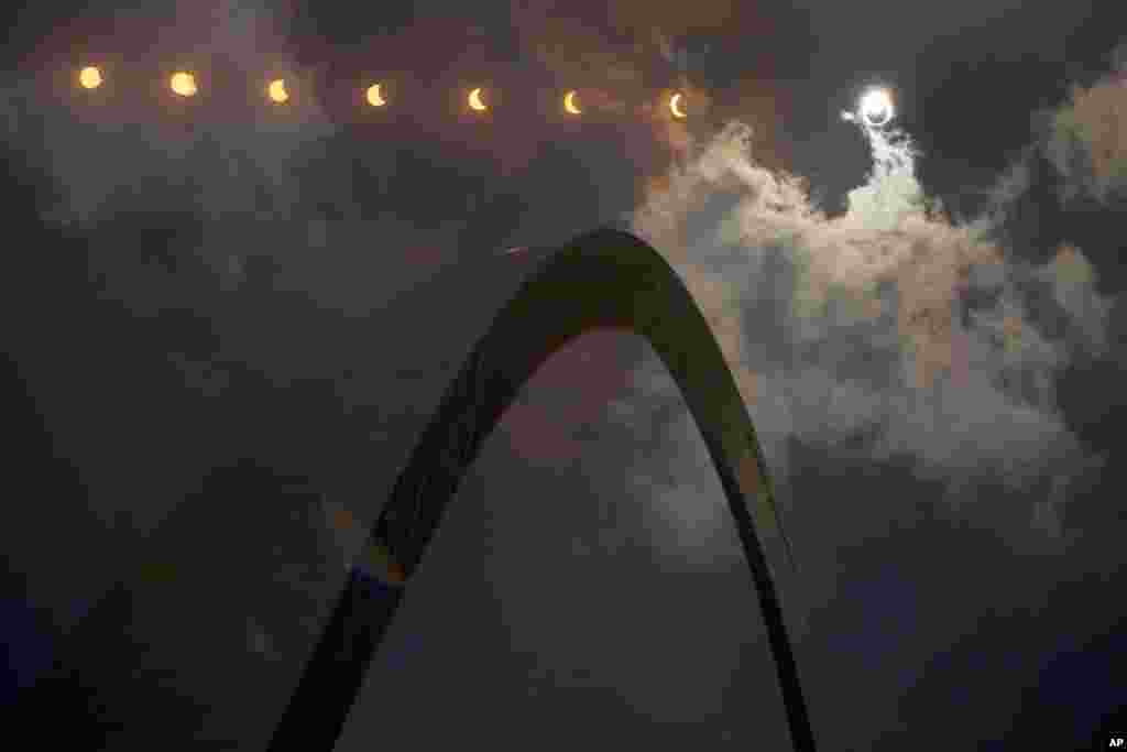 In this multiple exposure photograph, the phases of a partial solar eclipse are seen over the Gateway Arch on Monday, Aug. 21, 2017, in St. Louis. The Gateway Arch was just a few miles outside of the path of totality. (AP Photo/Jeff Roberson)