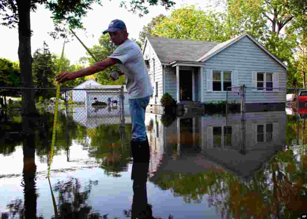 May 9: Arthur Burton measures floodwaters in Memphis, Tennessee.(REUTERS/Eric Thayer)