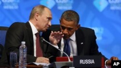 U.S. President Barack Obama (R) listens to Russia's President Vladimir Putin before the opening of the first plenary session of the G-20 Summit in Los Cabos, Mexico, June 18, 2012.