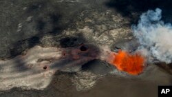 A fissure continues to blast fresh lava several hundred feet in the air and flow towards Kapoho as the Kilauea Volcano lower east rift zone eruption continues on June 6, 2018, in Pahoa, Hawaii. 