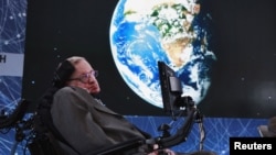 FILE - Physicist Stephen Hawking sits on stage during an announcement of the Starshot initiative with investor Yuri Milner in New York, April 12, 2016. A partnership was announced this week with the European Southern Observatory, which will use one of the