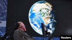 Physicist Stephen Hawking sits on stage during an announcement of the Starshot initiative with investor Yuri Milner in New York, April 12, 2016. A partnership was announced this week with the European Southern Observatory, which will use one of their telescopes to hunt for inhabitable planets.