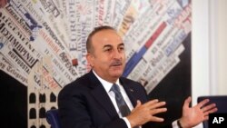 Turkish Foreign Minister Mevlut Cavusoglu talks at the Foreign Press Club, in Rome, Nov. 23, 2017.