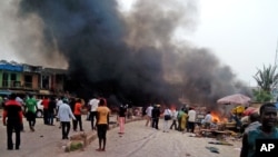Smoke rises after a bomb blast at a bus terminal in Jos, Nigeria, May 20, 2014. 