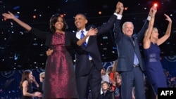 US President Barack Obama (2nd L), First Lady Michelle Obama (L), Vice-President Joe Biden and Second Lady Jill Biden wave to supporters following Obama's speech on election night November 6, 2012 in Chicago, Illinois.