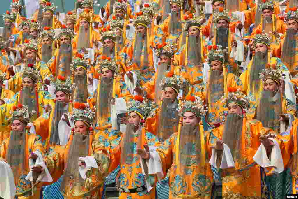 A total of 432 people wear dragon robe costumes in an attempt to set a Guinness Record for the most people performing Yu Opera together, in Zhengzhou, Henan province, China, Sept. 17, 2016