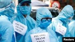 Medical healthcare workers wearing protective suits are seen at a testing center for COVID-19 in Hanoi, Vietnam, August 10, 2020.