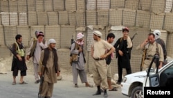 FILE - Afghan Local Police (ALP) keep watch at a checkpoint at Chardara district, in Kunduz province, Afghanistan, June 23, 2015. 