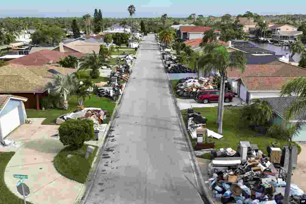 Debris from homes flooded in Hurricane Helene sits curbside as Hurricane Milton approaches, Oct. 8, 2024, in Port Richey, Florida.