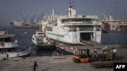 FILE—A dock worker places cones in front of the ferry that travels between Dakar and Ziguinchor in Dakar, on April 9, 2024.