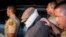 Nakoula Basseley Nakoula (C) is escorted out of his home by Los Angeles County Sheriff's officers in Cerritos, California Sept. 15, 2012.