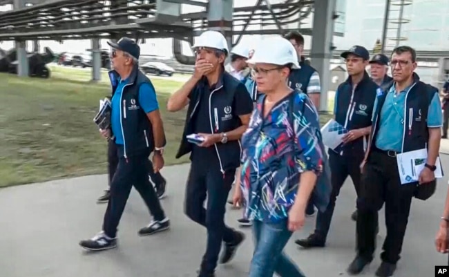 In this handout photo taken from video released by Russian Defense Ministry Press Service on Sept. 2, 2022, International Atomic Energy Agency (IAEA) director Rafael Grossi, center, and IAEA members inspect the Zaporizhzhia nuclear power plant in Enerhodar, southeastern Ukraine, Sept. 1, 2022.