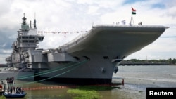 Indian Navy officers stand on the flight deck of India's first home-built aircraft carrier INS Vikrant after its commissioning ceremony at a state-run shipyard in Kochi, India, Sept. 2, 2022.