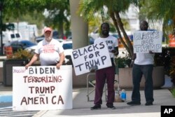 Supporters of former President Donald Trump stand outside the Paul G. Rogers Federal Building and U.S. Courthouse, in West Palm Beach, Fla., Sept. 1, 2022.