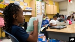 A third-grade student reads to the rest of her class at Beecher Hills Elementary School on , Aug. 19, 2022, in Atlanta. 