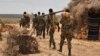 FILE - A handout photo taken June 10, 2016, and released by AMISOM shows soldiers serving under the African Union Mission in Somalia (AMISOM) on foot patrol in Halgan village, Hiran region. Civilians in the region have been targeted by recent al-Shabab attacks.