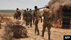 FILE - A handout photo taken June 10, 2016, and released by AMISOM shows soldiers serving under the African Union Mission in Somalia (AMISOM) on foot patrol in Halgan village, Hiran region. Civilians in the region have been targeted by recent al-Shabab attacks.