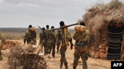 FILE - A handout photo taken June 10, 2016, and released by AMISOM shows soldiers serving under the African Union Mission in Somalia (AMISOM) on foot patrol in Halgan village, Hiran region. Civilians in the region have been targetted by recent al-Shabab a