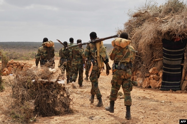 FILE - A handout photo taken June 10, 2016, and released by AMISOM shows soldiers serving under the African Union Mission in Somalia (AMISOM) on foot patrol in Halgan village, Hiran region.