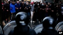Supporters of Argentina's Vice President Cristina Fernandez face off with police as they try to show their solidarity after prosecutors asked a judge to sentence Fernandez to 12 years in prison for allegedly leading a criminal conspiracy, in Buenos Aires, Argentina, Aug. 27, 2022.