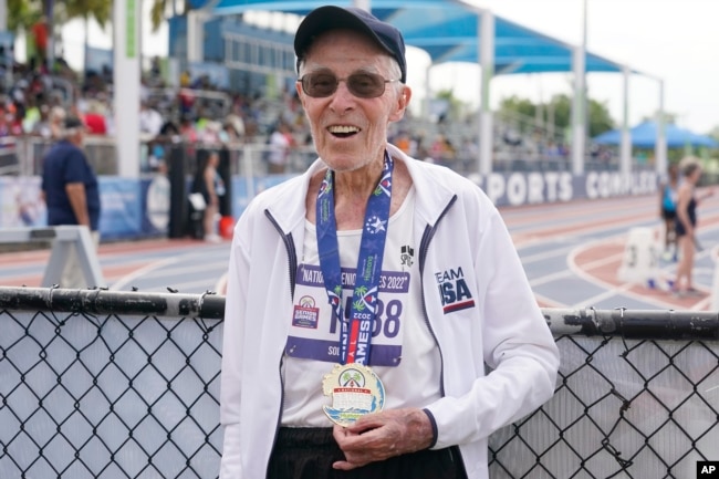 FILE - Richard Soller holds the medal he won in the 200 meter final at the National Senior Games, Monday, May 16, 2022, in Miramar, Fla. (AP Photo/Marta Lavandier)
